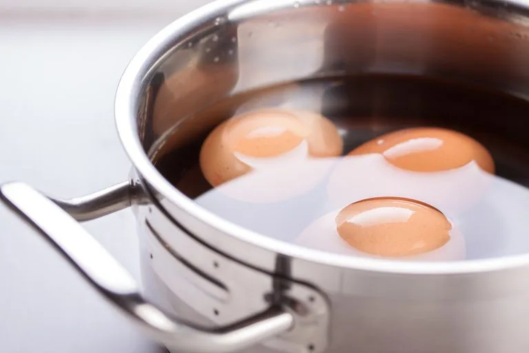 Raw eggs in a metal pan